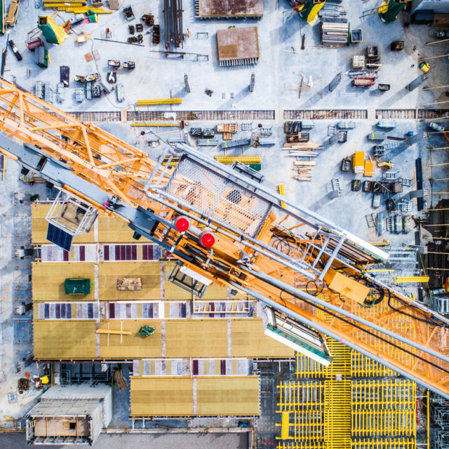 Nadir view of an industrial site, with cranes, concrete work, and more.