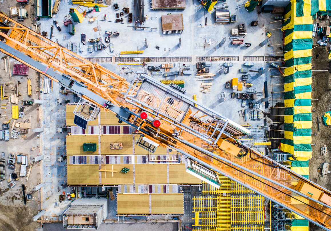 Nadir view of an industrial site, with cranes, concrete work, and more.